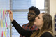 A lecturer showing a student writing on a white board