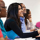 A masters student looking towards the board during a lecture