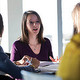 A woman giving administrative advice to two people
