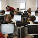 Students working in a room filled with computers, attending homework club
